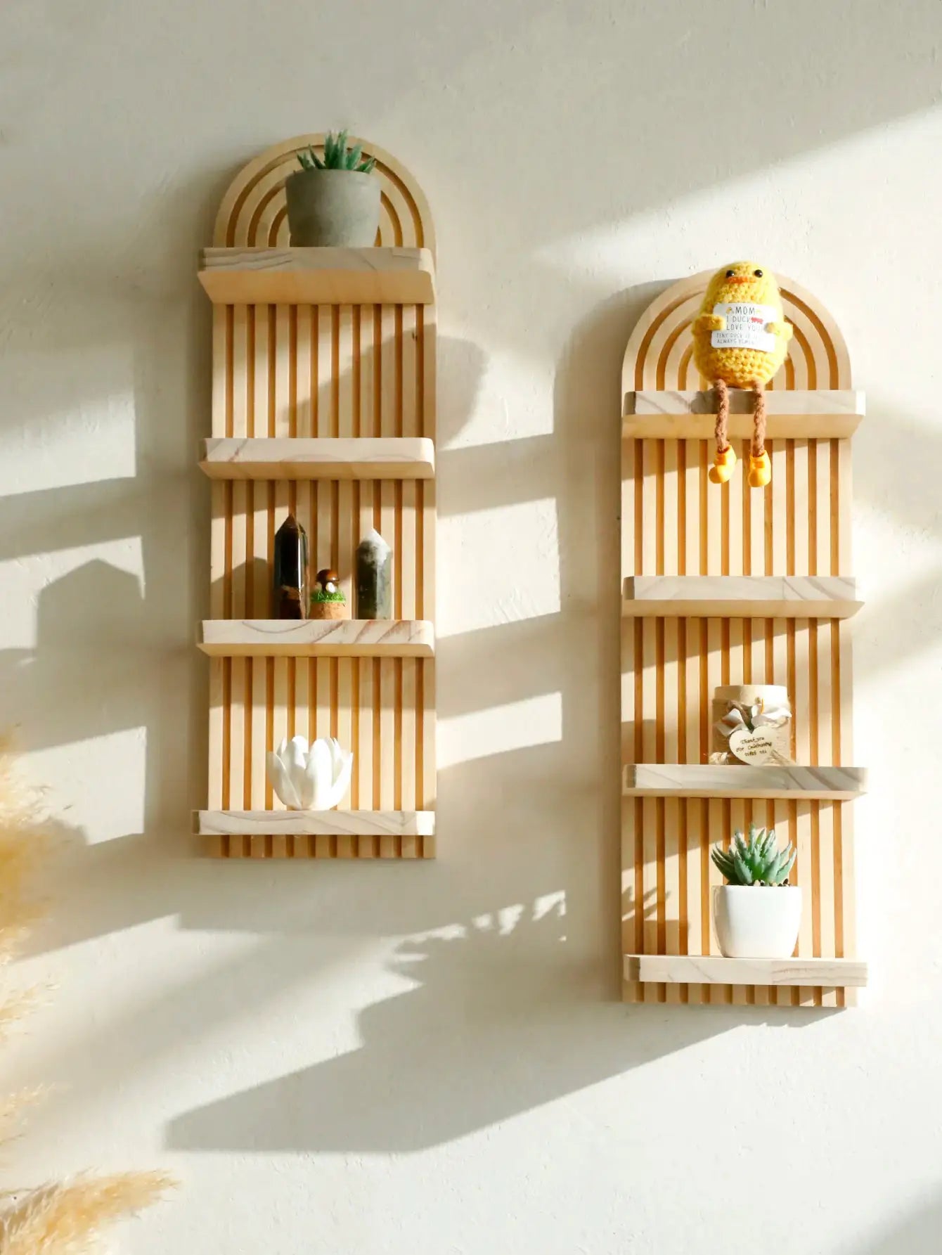 Two boho-style wooden wall shelves with arched tops and a natural wood finish by Simples Market