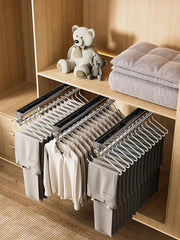 Pull-out trouser hangers wardrobe organizer with three rails of white non-slip hangers