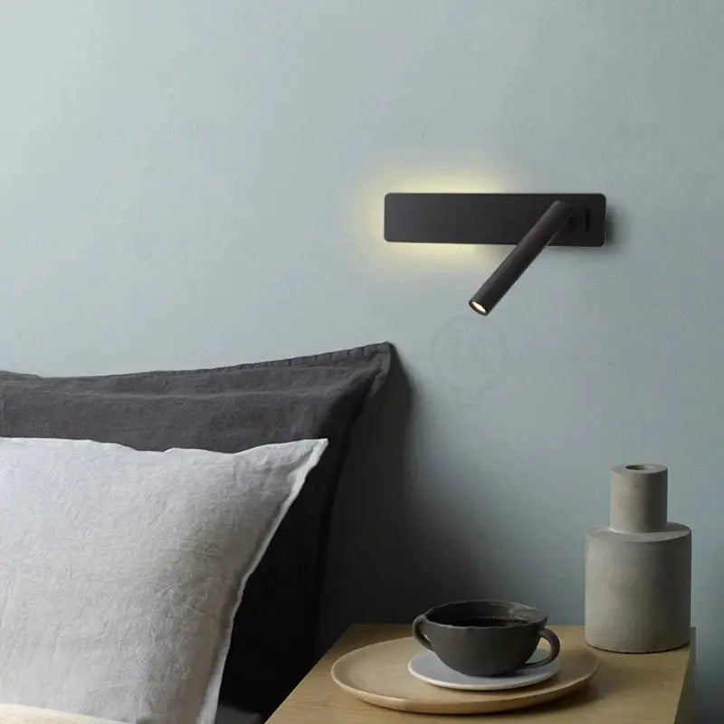 LED wall reading lamp, black minimalist bedside sconce casting warm light by the bed