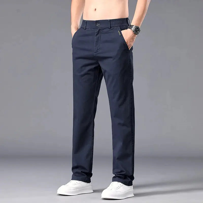 Men's navy straight-fit casual chinos with belt loops and front pockets, paired with white sneakers.