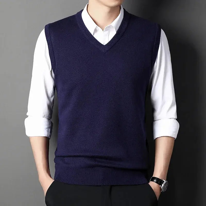 Mens navy V-neck knitted vest, solid color, layered over white shirt.