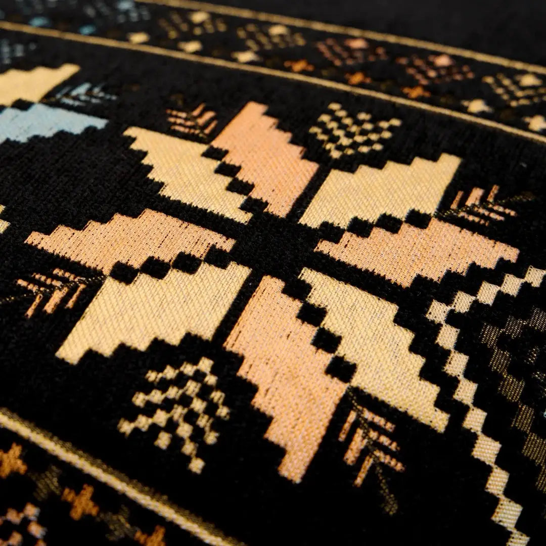 Sofa cover in Bohemian jacquard chenille with black, tan, peach and blue geometric pattern
