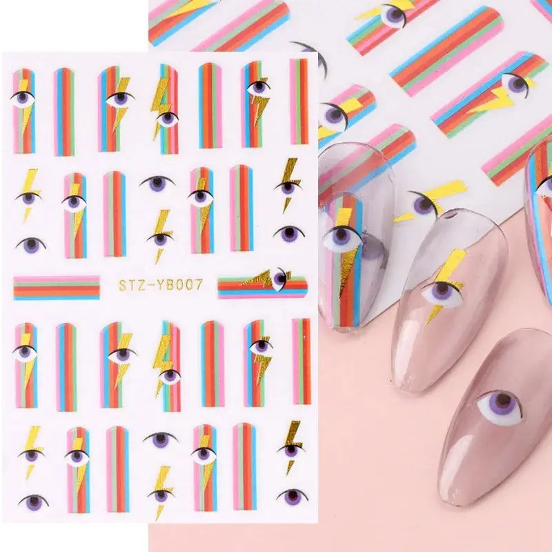 Nail art decals sheet by Simples Market; 1 sheet of colorful bronzing striped patterns with gold foil and eye motifs.