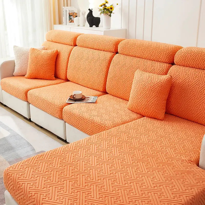 Orange jacquard sofa slipcover with stretch and matching cushions on a white sectional couch