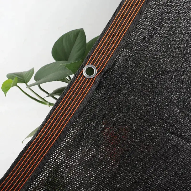 6x6m black shade cloth with metal grommets and orange-stitched edging from Simples Market for sunshade use
