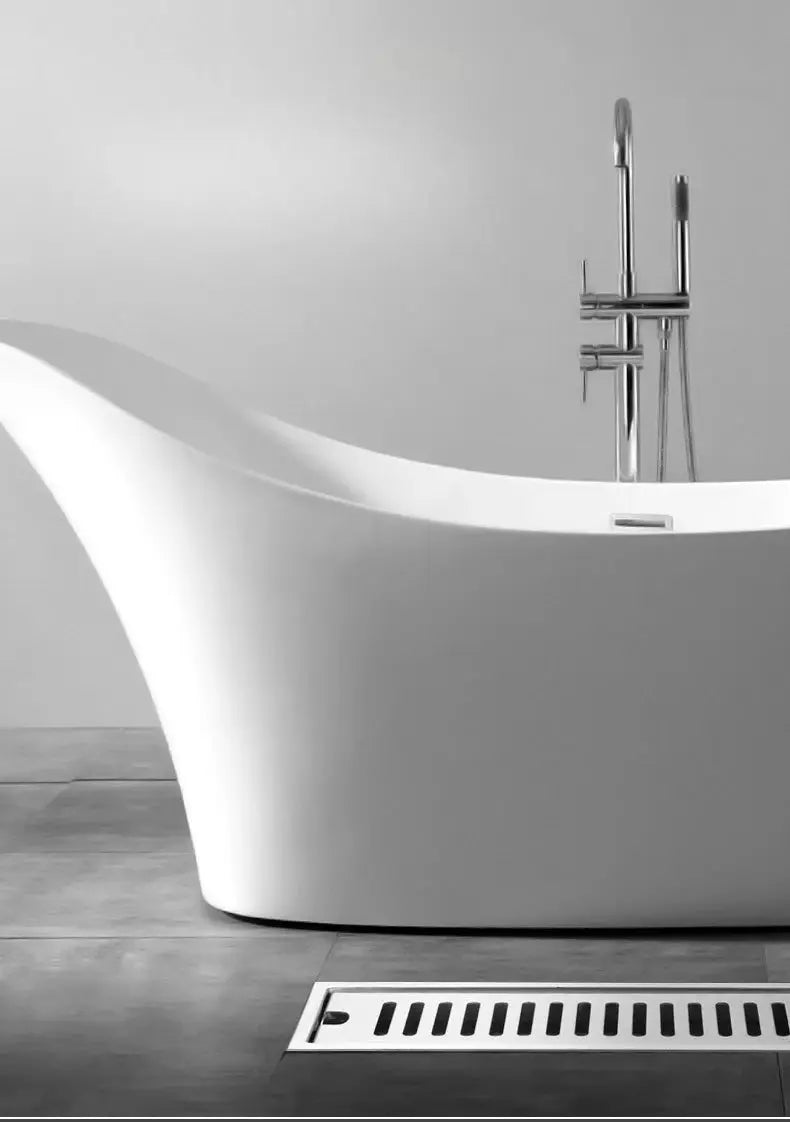 Long floor drain in bathroom; stainless steel 304, rectangular, near a white freestanding bathtub