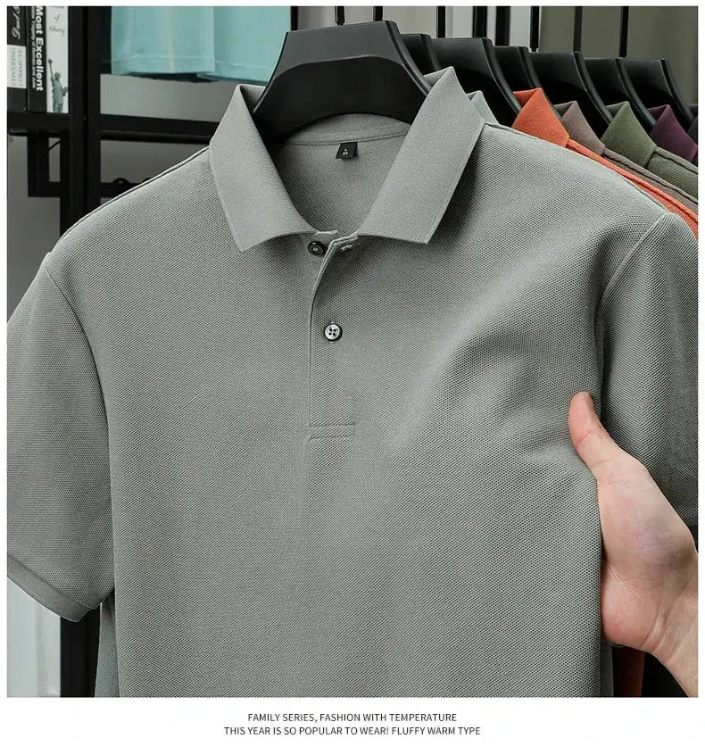 Men's polo shirt by Simples Market; gray 100% cotton polo on hanger with several color options visible.