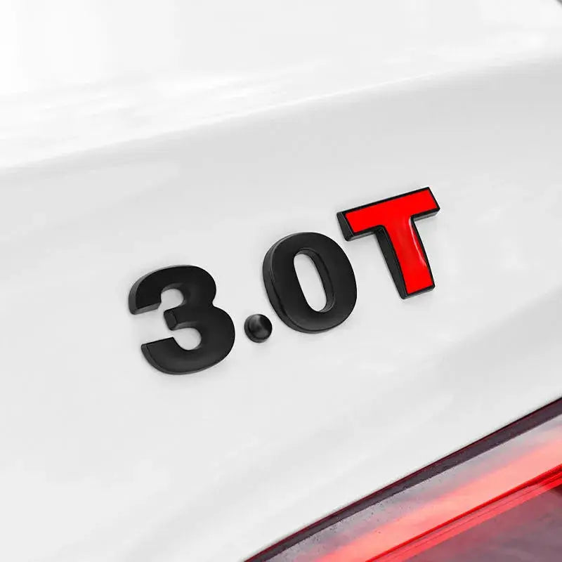 3D metal car badge reading 3.0T; black characters with red T on white car trunk.