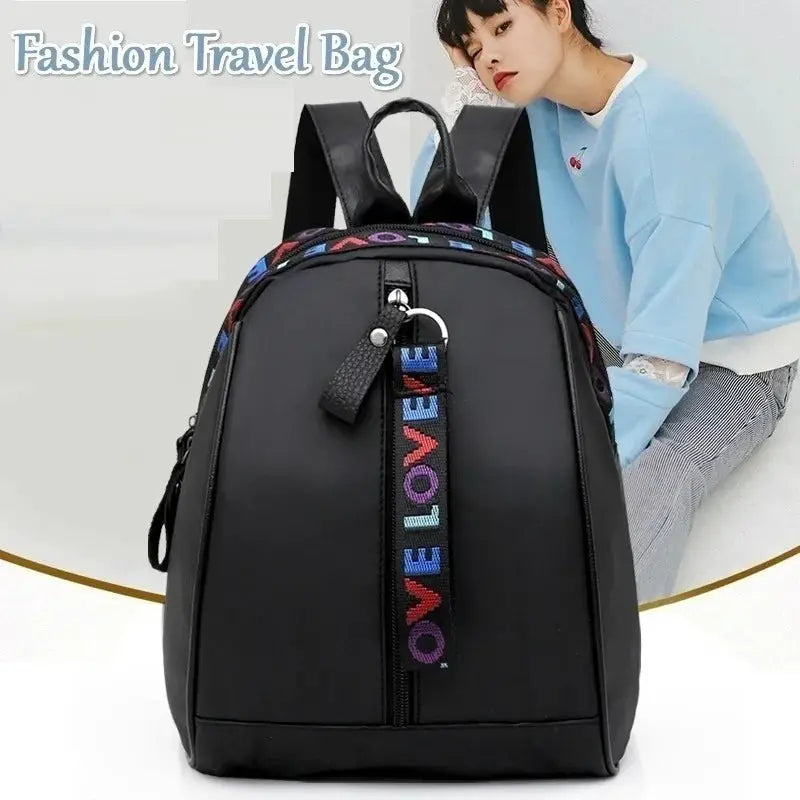 Mini black backpack by Simples Market; compact canvas fashion bag with colorful LOVE strap