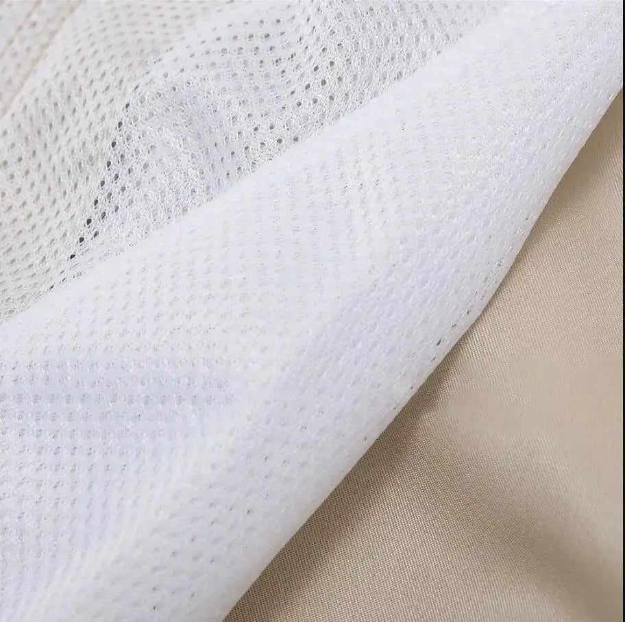 Men's swim trunks by Simples Market, fabric close up shows white mesh overlay on beige material