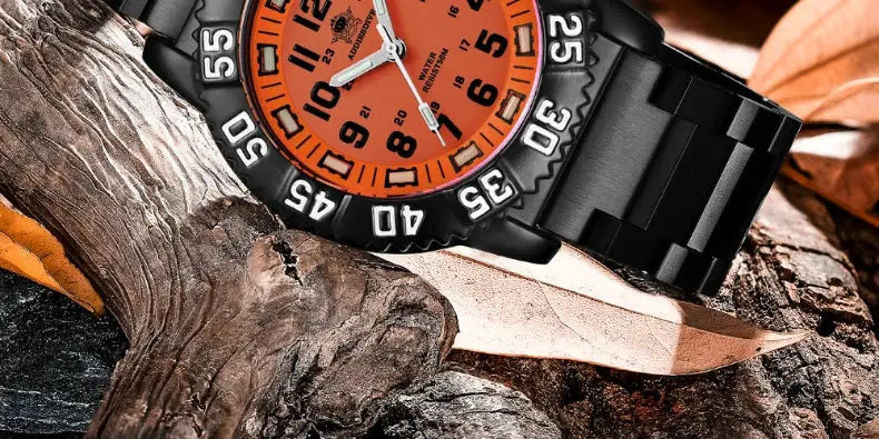 Men's military-style watch with orange dial and black metal strap on wood background