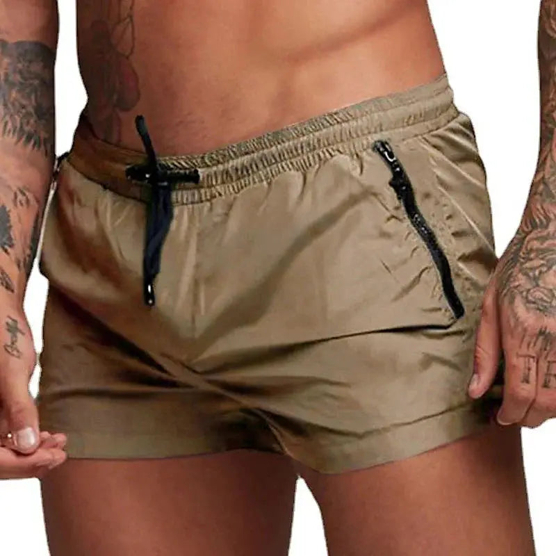 Men's beige swim trunks with black drawstring and zippered pockets by Simples Market