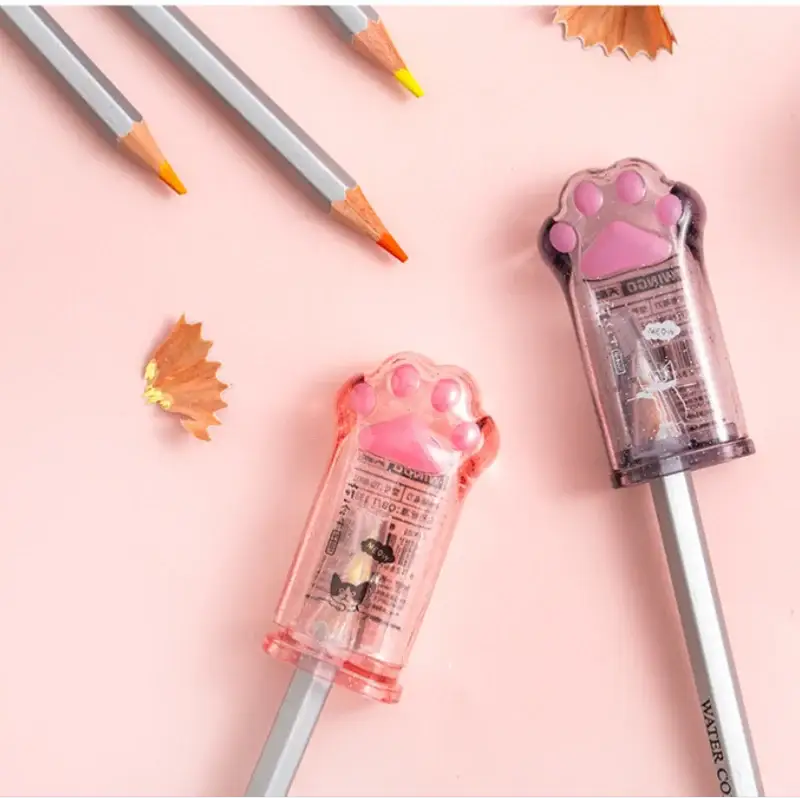 Kawaii cat paw pencil sharpener set by Simples Market, two pink and purple translucent sharpeners on pencils for Korean school supplies.