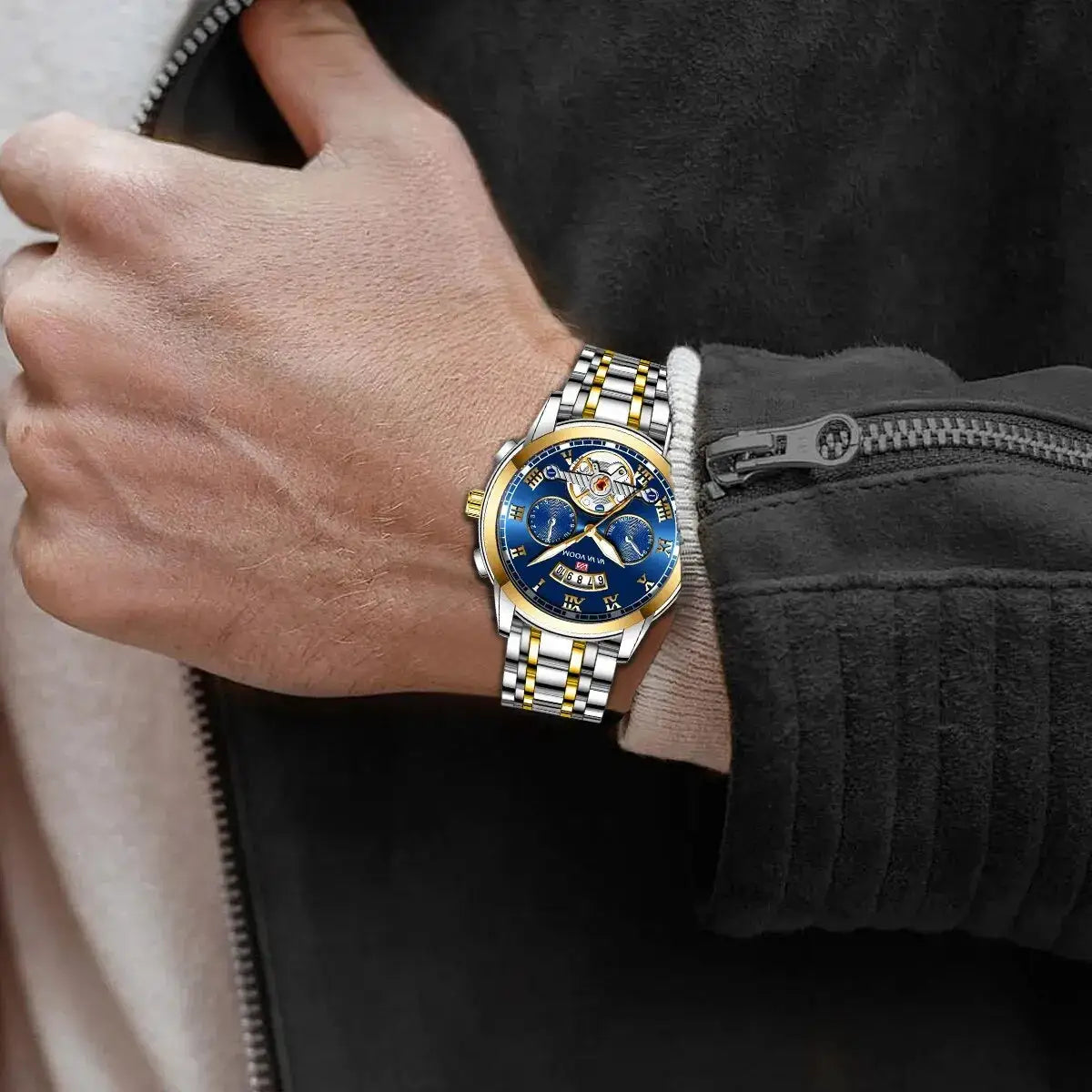 Men's luxury stainless steel watch with blue dial, gold accents and skeleton movement on a two-tone bracelet