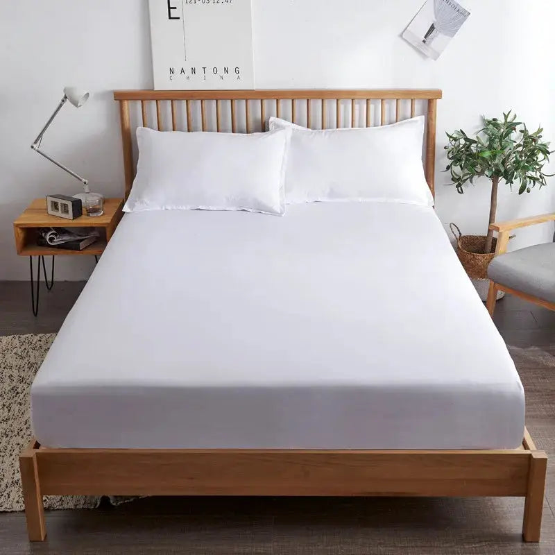 3-piece cotton fitted bed sheet set with 1 fitted sheet and 2 white pillowcases on a white bed
