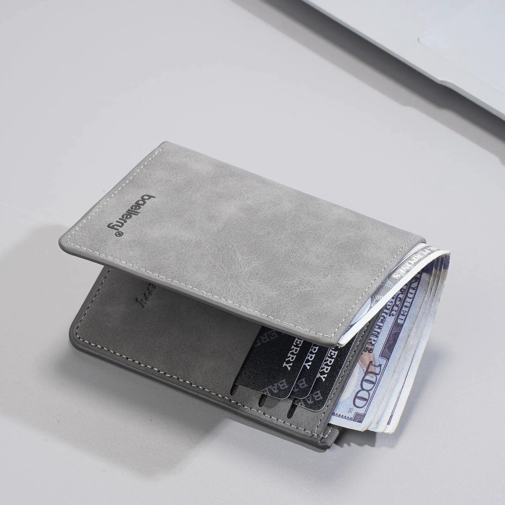 Baellerry men's short bi-fold RFID anti-theft wallet in grey leather with card slots and cash visible.