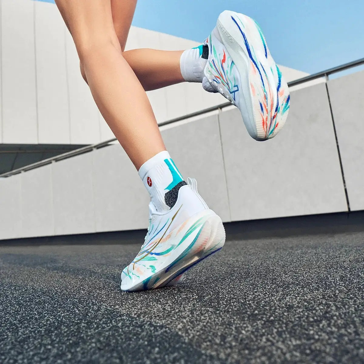 Xtep 2000km 5.0 running shoes; white with teal, blue and orange abstract pattern