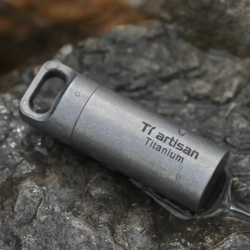Tiartisan Titanium mini EDC pill bottle by Simples Market; compact gray, waterproof titanium container.