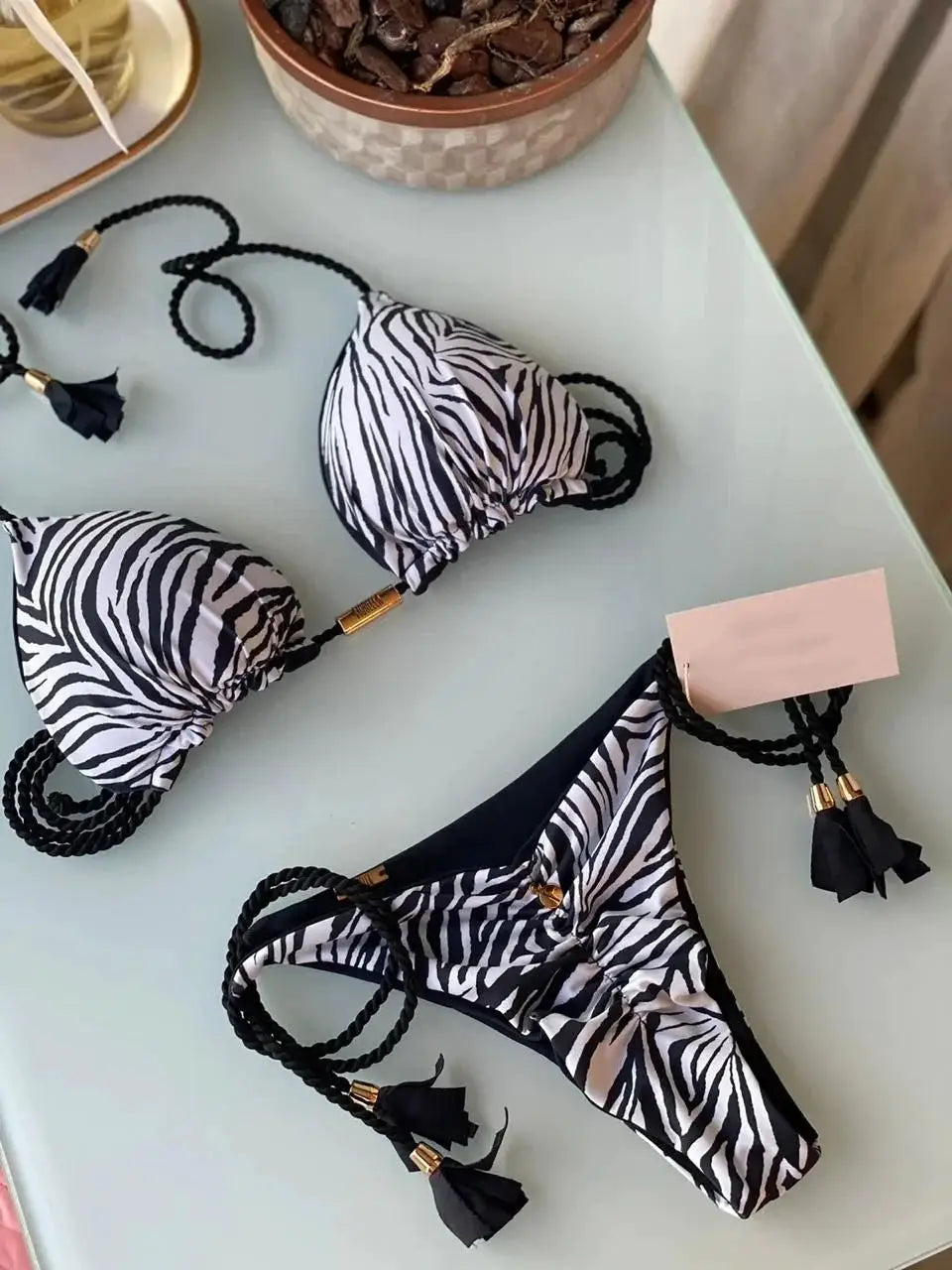Two-piece bikini set by Simples Market in black-and-white zebra print with backless rope-tie triangle top and bottoms