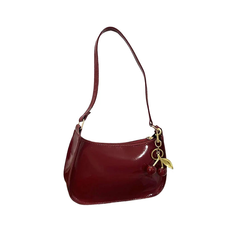 Women's PU leather shoulder bag in cherry red with gold-tone hardware and cherry pendant charm, Simples Market.