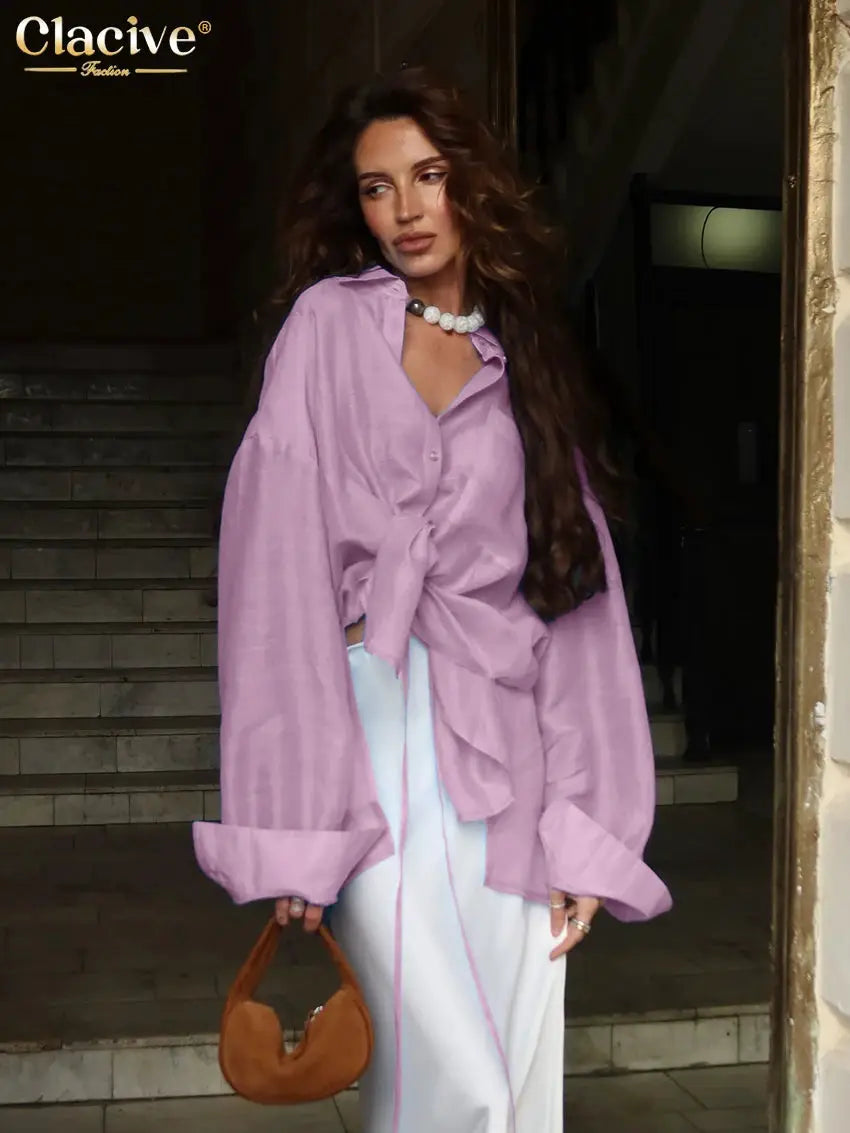 Clacive purple blouse with loose fit, long sleeves, and front knot; logo visible
