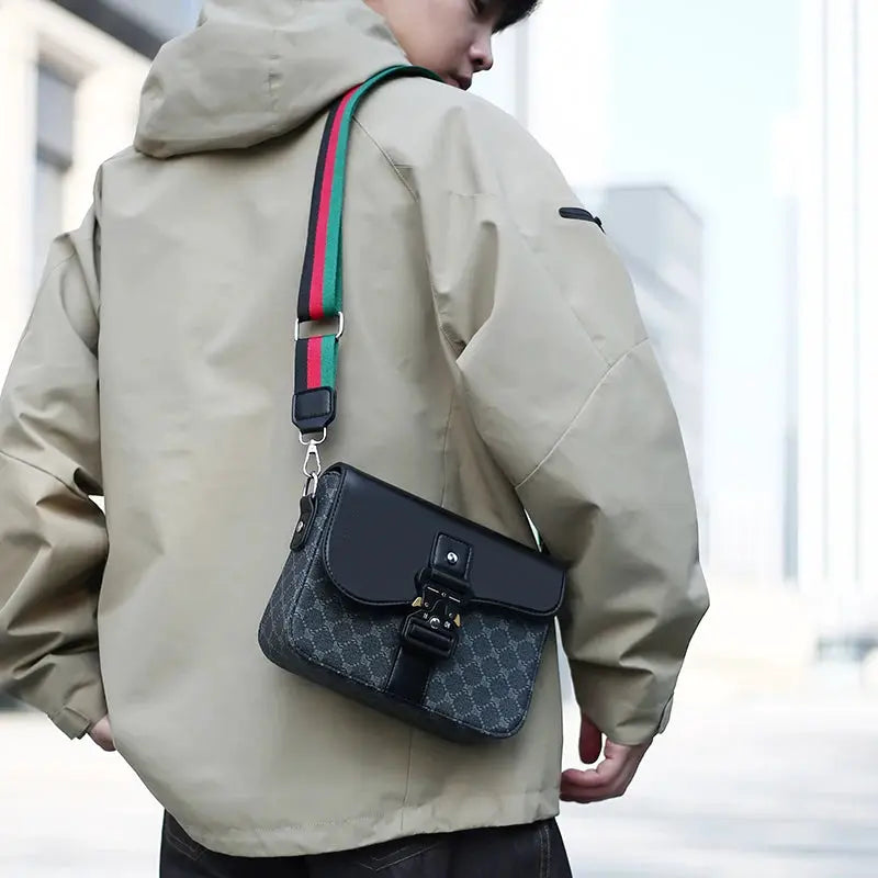 Crossbody bag with jacquard pattern and striped green-red strap for daily commuting.