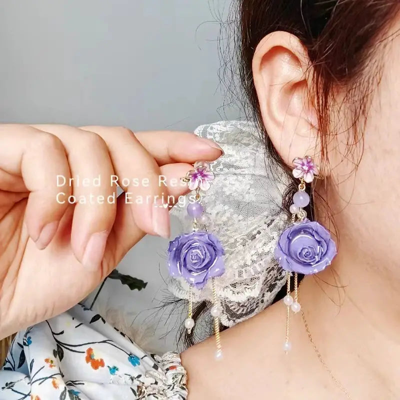 Immortal Rose long earrings pair with lavender epoxy rose pendants and pearl-bead dangle chains.