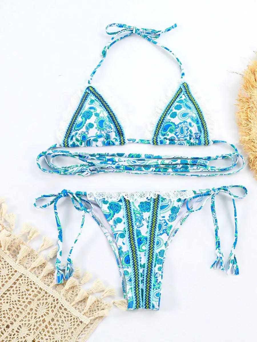 Two-piece bikini swimsuit in turquoise paisley print with white crochet lace trim and side-tie bottoms