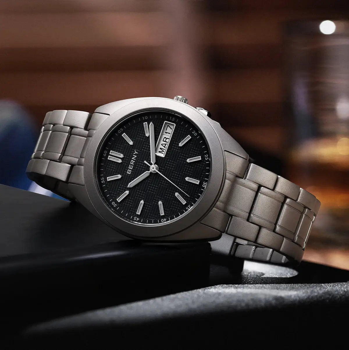 BERNY titanium men's wristwatch with black textured dial, date window, and silver metal bracelet, 38mm
