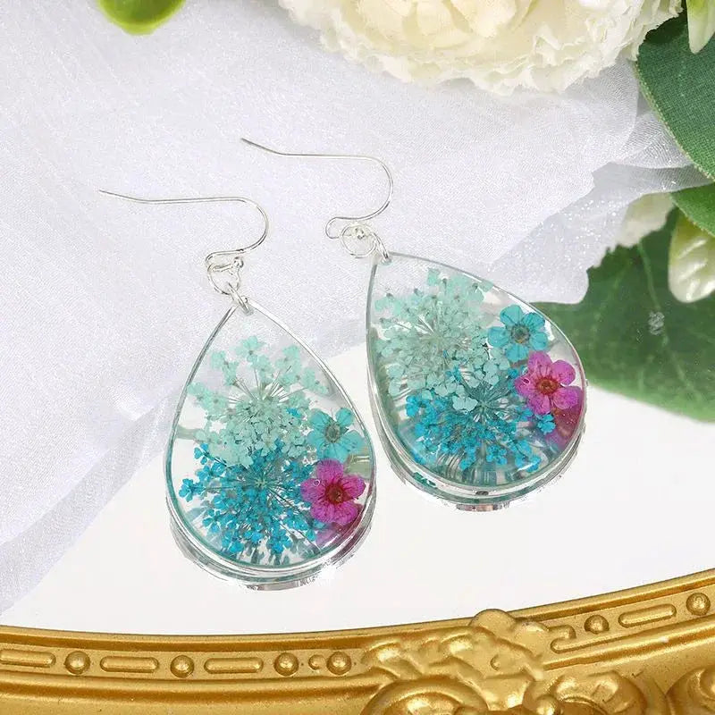 Teardrop epoxy resin earrings with pressed blue, teal and pink flowers; silver hooks, Simples Market