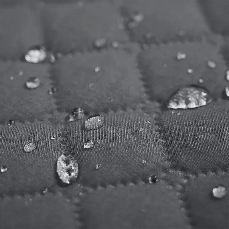 Sofa armrest cover with pockets; gray quilted, water-repellent slipcover by Simples Market.