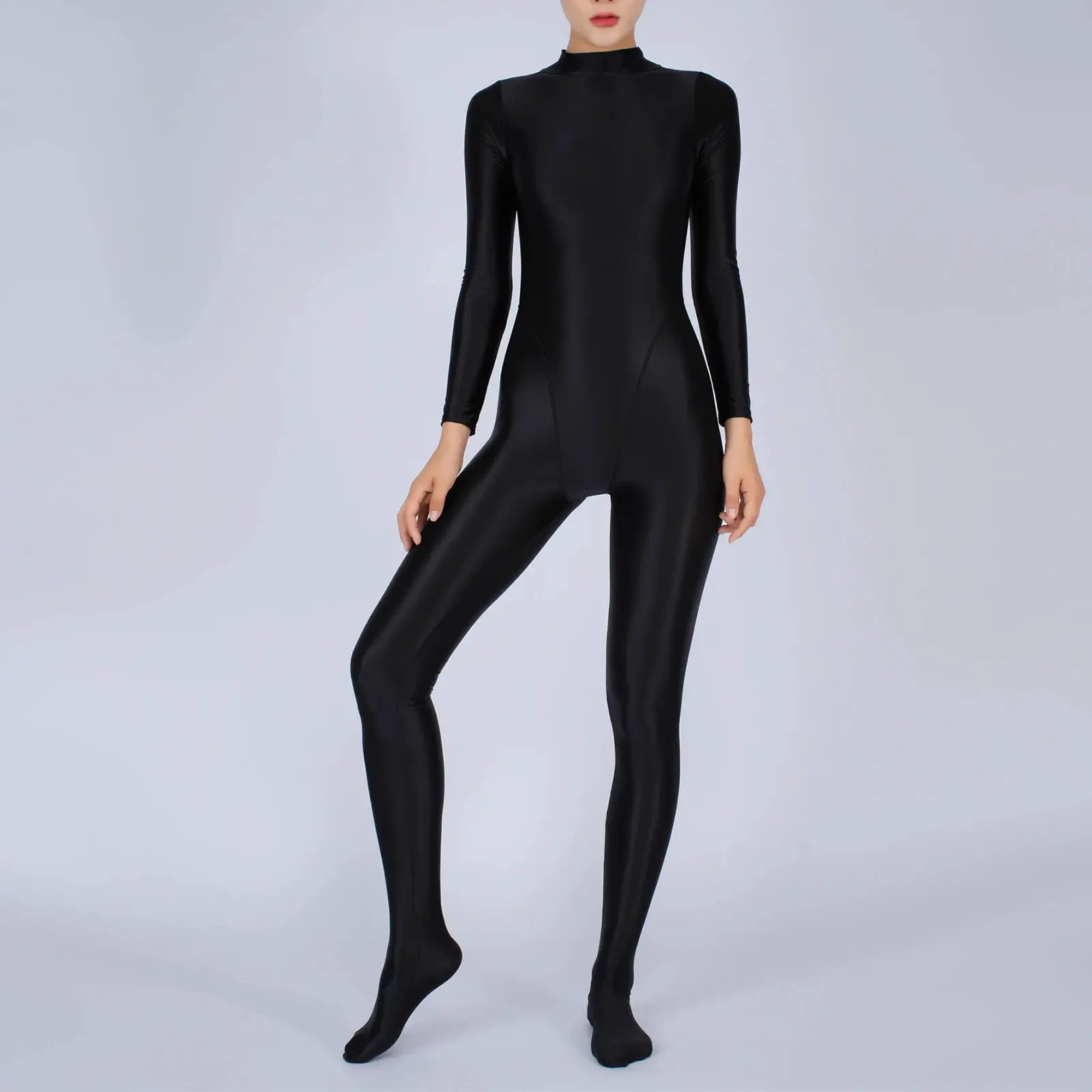 Women's full-body black jumpsuit with long sleeves and footed legs in a shiny stretch fabric.
