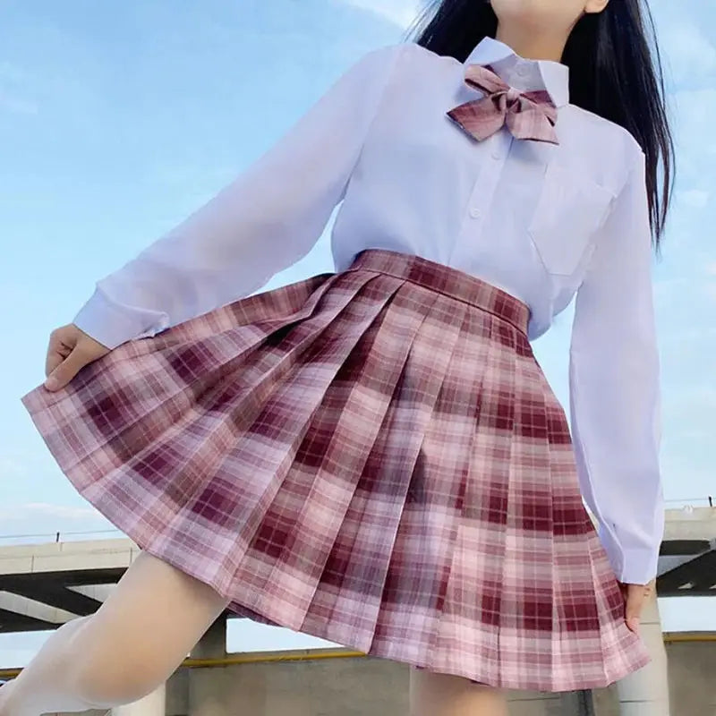 ZOKI plaid pleated skirt, high-waisted pink check print, paired with white blouse and bow.
