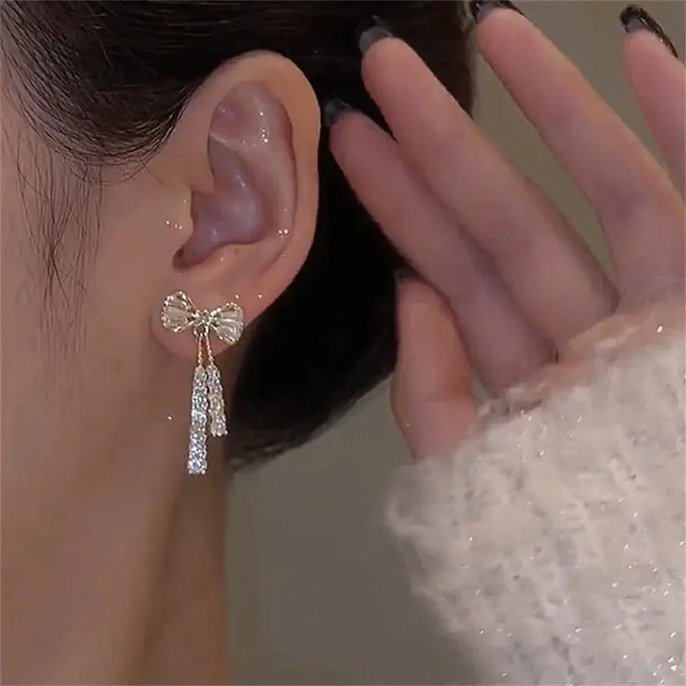 Fashion bow crystal zircon earrings, gold-tone with dangling crystal bar drops