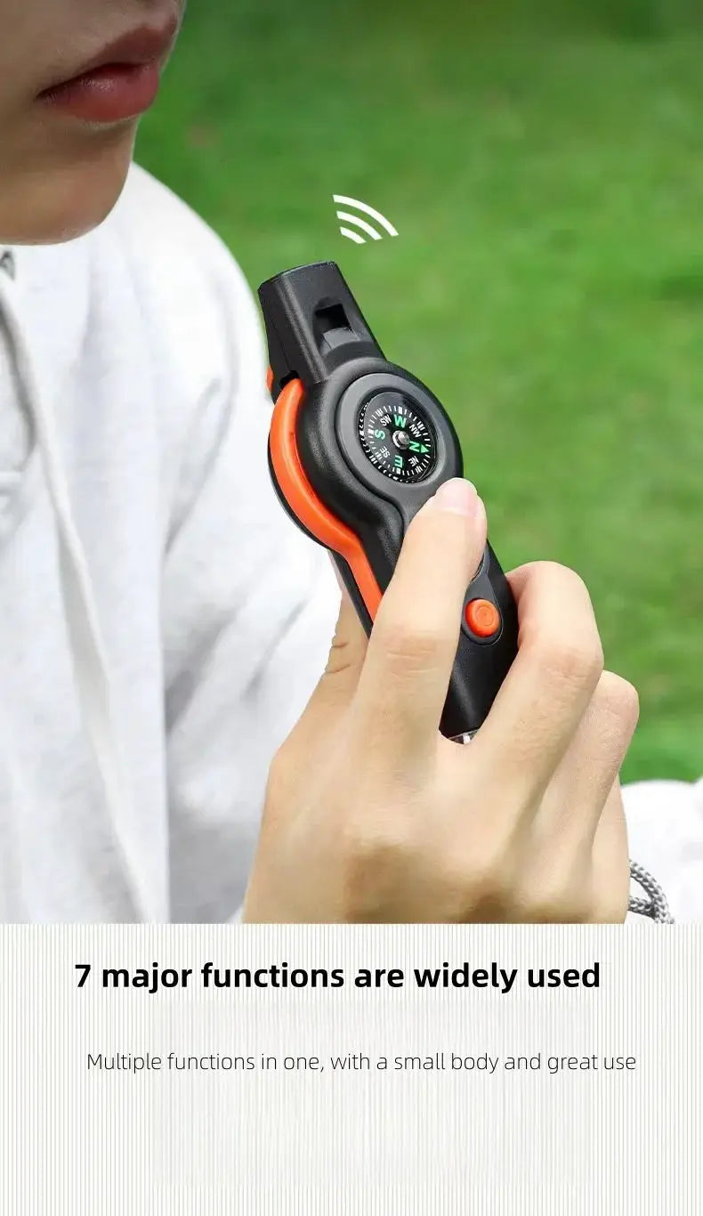 Outdoor camping 7-in-1 survival whistle with built-in compass, Simples Market; black with orange accents.