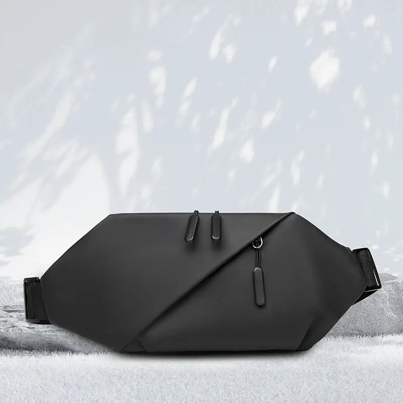 Men's minimalist outdoor waist bag, black waterproof fanny pack with diagonal design and dual zippers.
