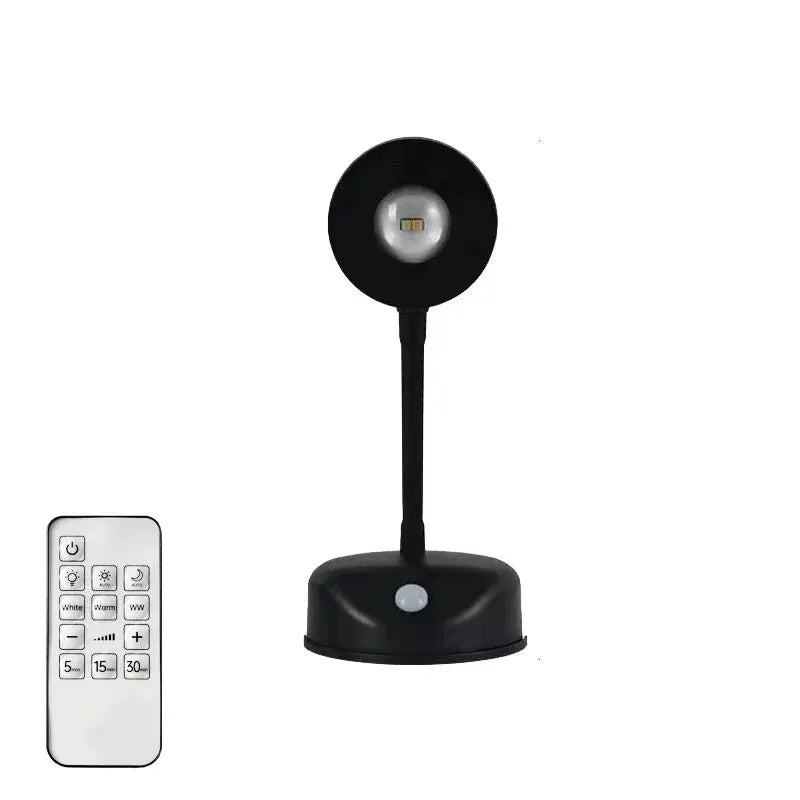 LED night light with motion sensor, black wireless USB lamp on a stand; remote control included.