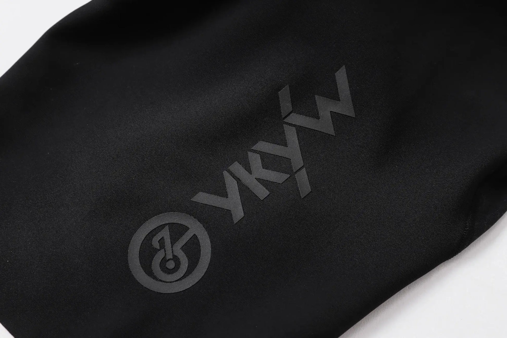 Cycling bib shorts in black fabric with subtle logo, Simples Market YKYWBIKE branding