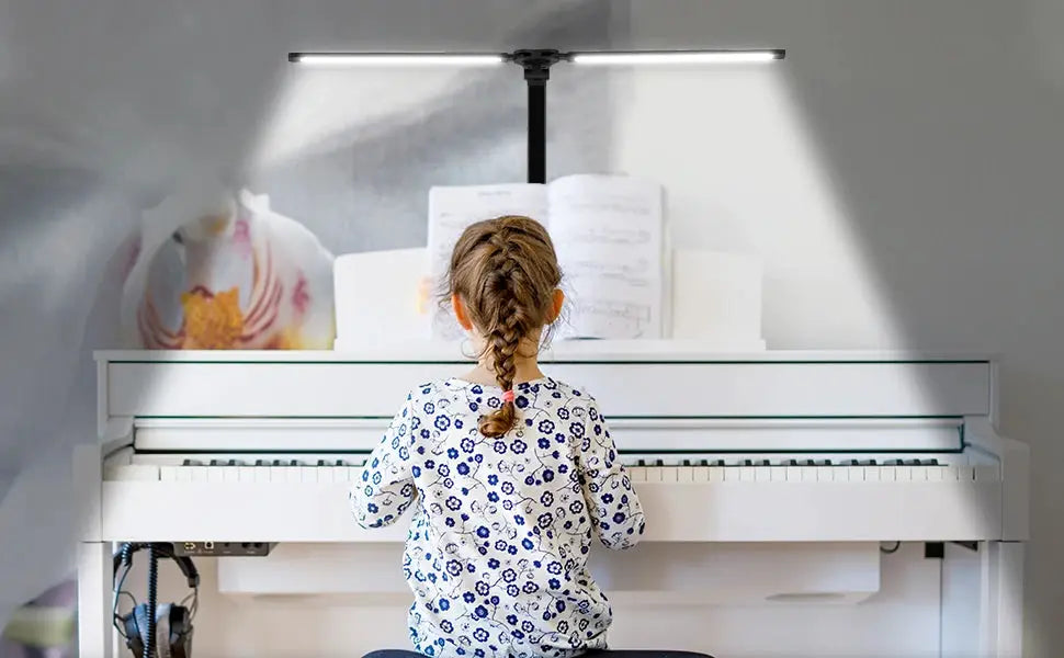 Simples Market double-head LED desk lamp with black finish and dual swing arms over a white piano.