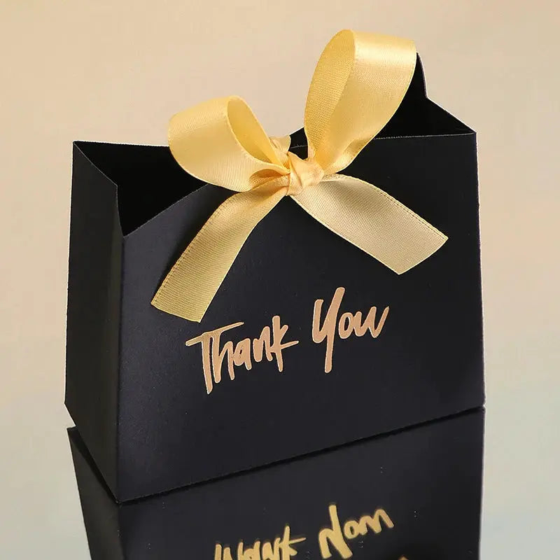 Simples Market black gift box with gold ribbon bow and Thank You text.