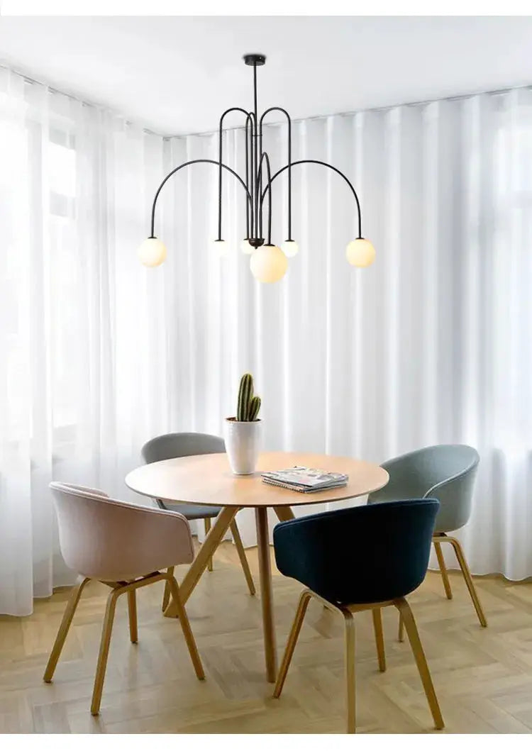 Nordic Minimalist Pendant Light by Simples Market with black metal arches and globe bulbs.