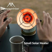 Mountainhiker portable mini gas stove heater with orange glow on table; Simples Market watermark