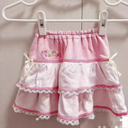 Sweet Lolita cake mini skirt in pink and white with lace-trimmed tiers, bow accents, and embroidery.