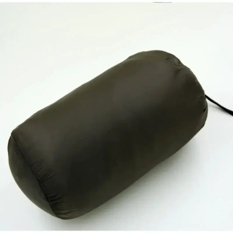 Down jacket packed in a dark gray cylindrical stuff sack with drawstring