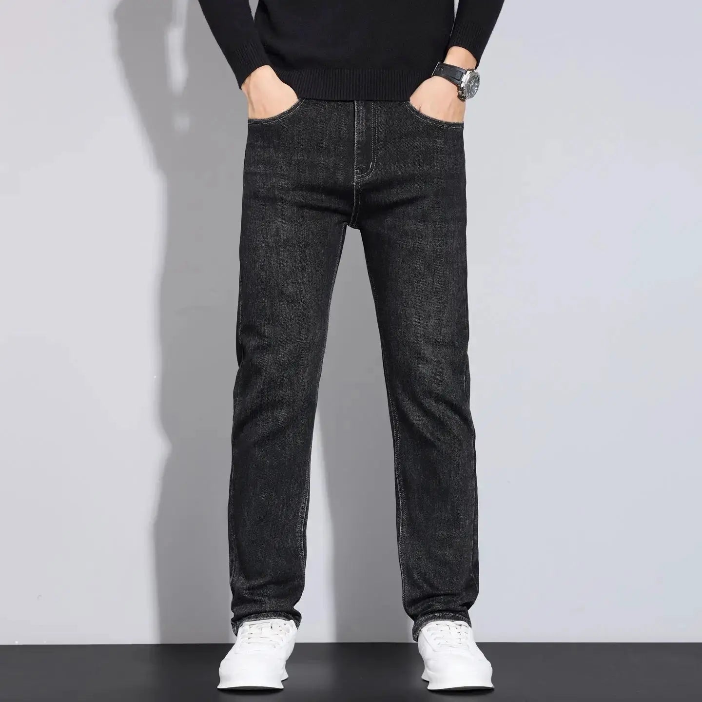 Men's dark denim jeans, straight-leg fit with front pockets, shown with white sneakers