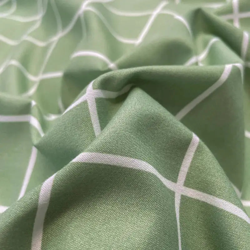 Nordic plaid cotton bedding set in green with white grid lines by Simples Market; includes duvet cover and pillowcases.