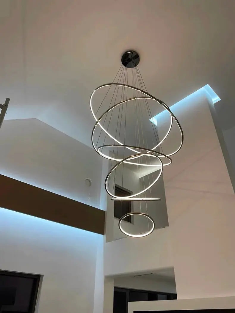 Pendant light fixture with multi-loop metallic LED rings, modern staircase chandelier by Simples Market