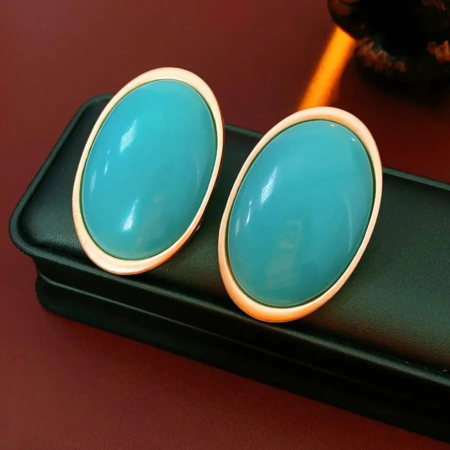 Pair of teal resin oval stud earrings with large gold-tone bezel