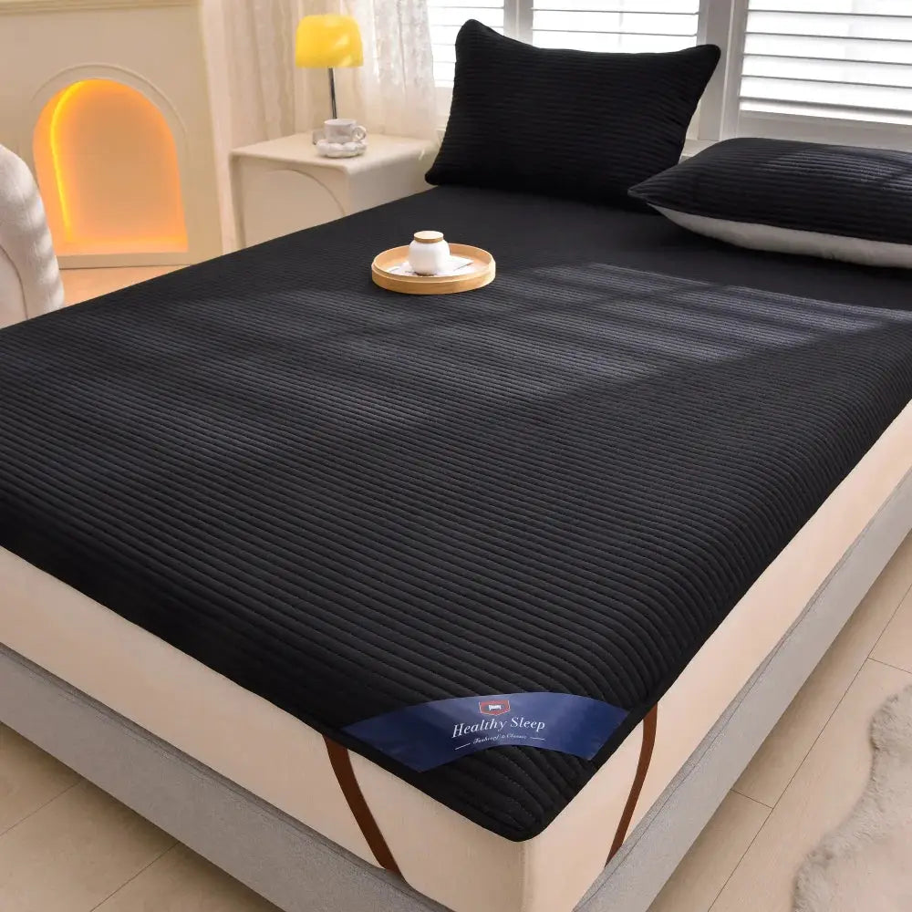 Striped waterproof mattress protector by Simples Market on a bed, black, soft and breathable.