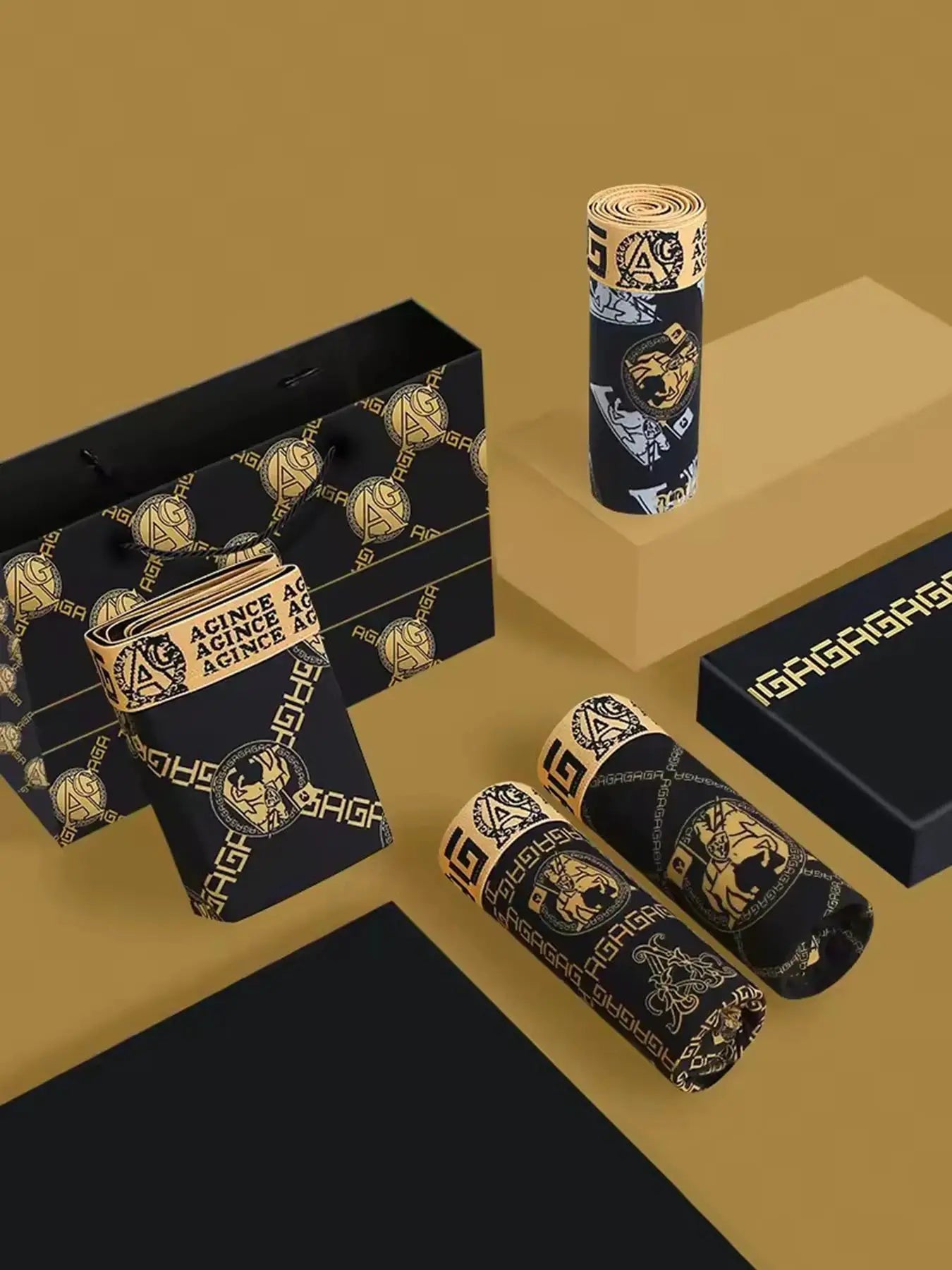 4-piece men's boxer shorts set in black and gold retro print, shown with matching black and gold packaging.